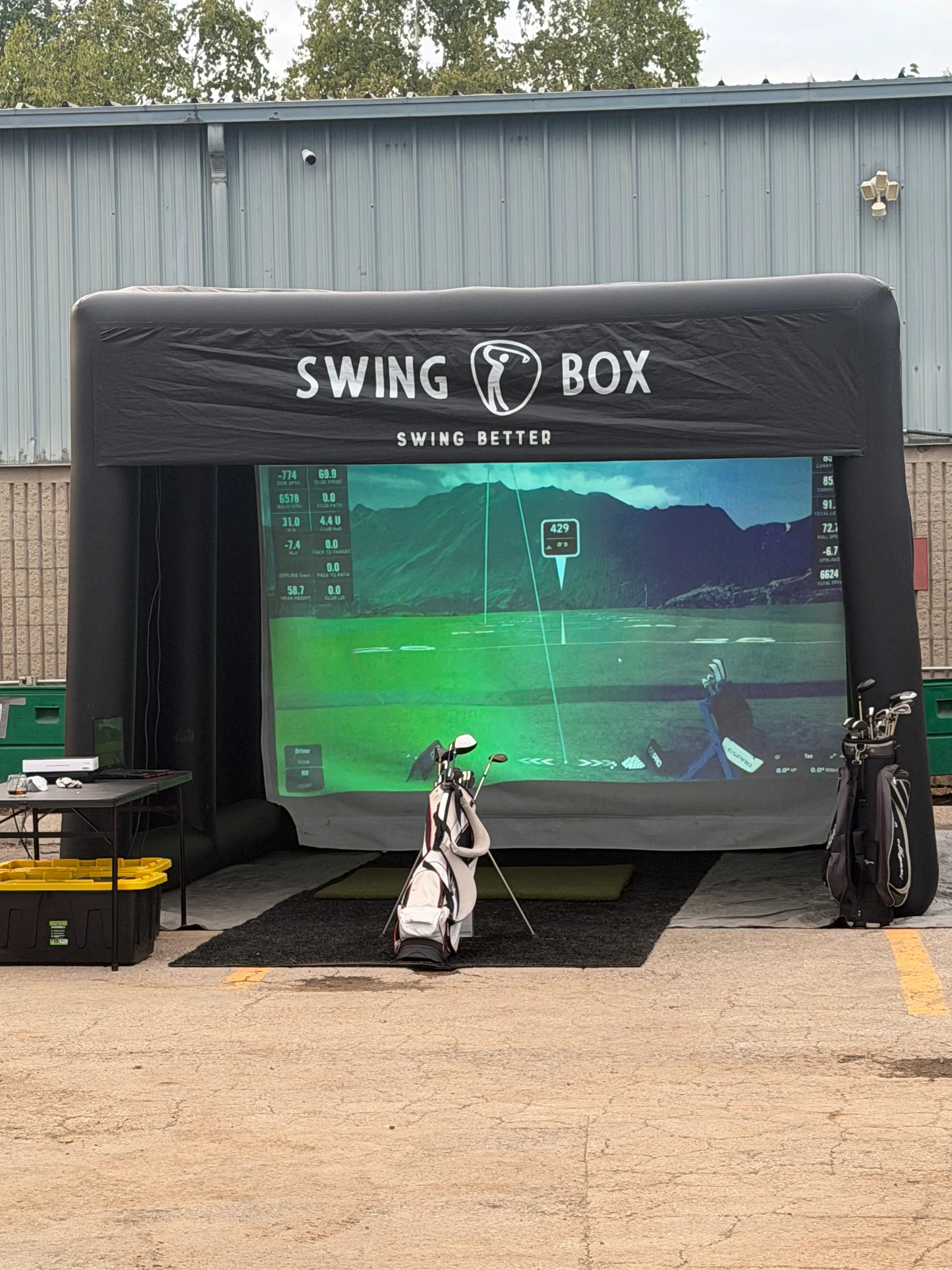 Complete outdoor Swing Box enclosure with projection screen, hitting mat and golf bags